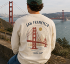 man wearing san francisco shirt in front of golden gate bridge
